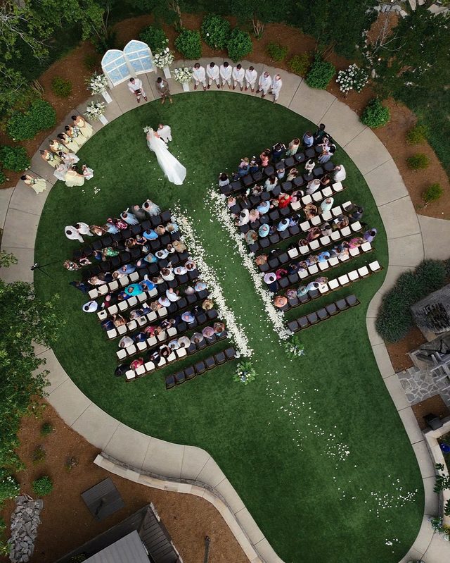 Aerial view of Emma and Philip’s outdoor ceremony ringed by guests.