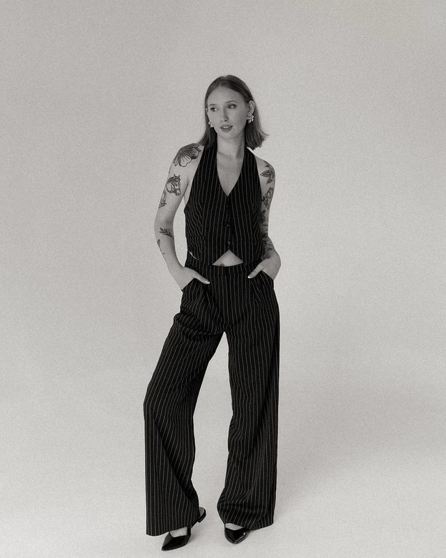 Portrait of Kate Ming in a pinstripe suit, photographed in black and white.