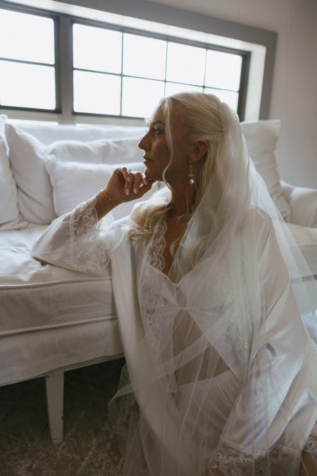 Emma resting on a sofa in her veil before the ceremony.
