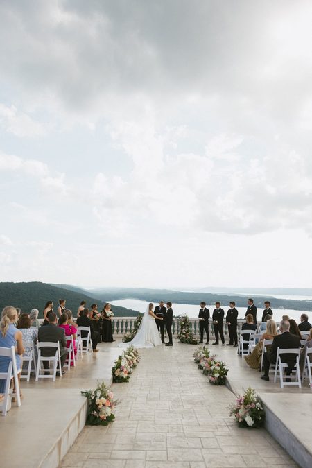 The ceremony on the stone terrace, the lake and hills beyond.