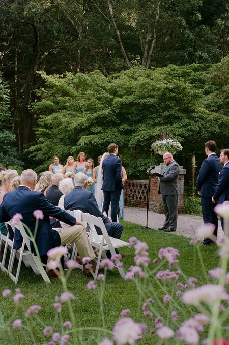 The ceremony in the back gardens, seen through the wildflowers.