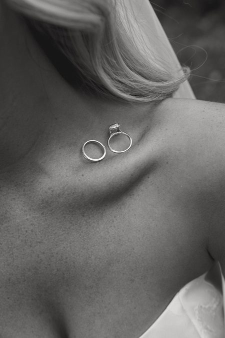 The rings resting on Stephanie’s collarbone, in black and white.